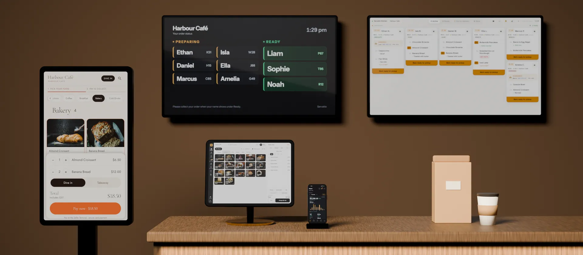 A Servatto self-order Kiosk in front of the Kitchen display and the customer Screen, with Servatto Register and an iPhone running the Manager app.